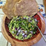 Best homemade authentic Mexican guacamole in bowl, served with tostadas